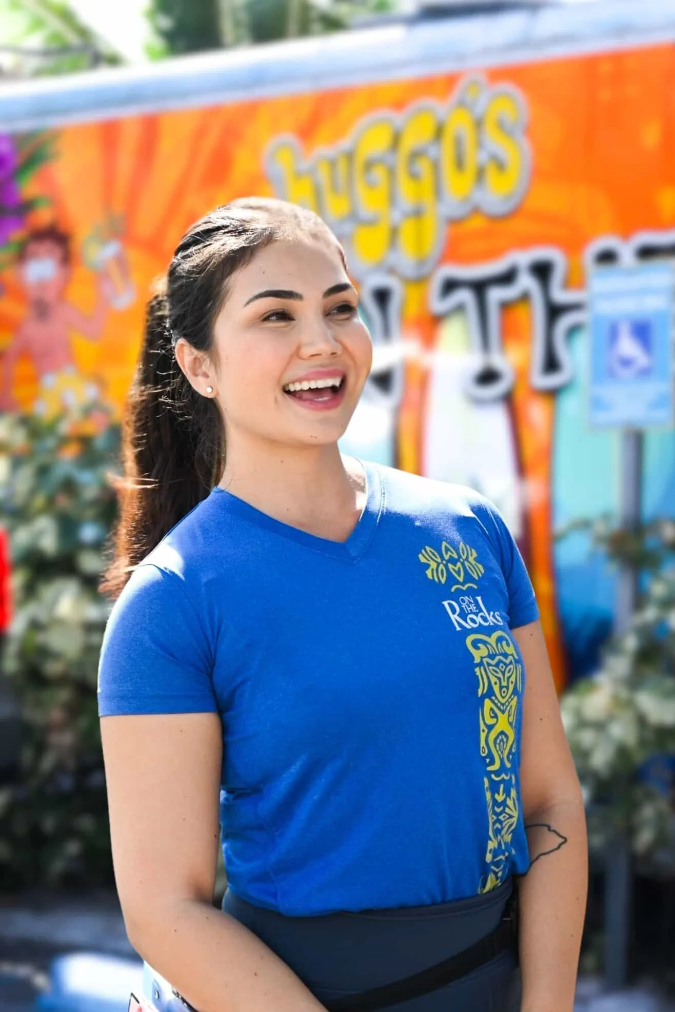 Smiling On the Rocks team member in front of the painted food truck
