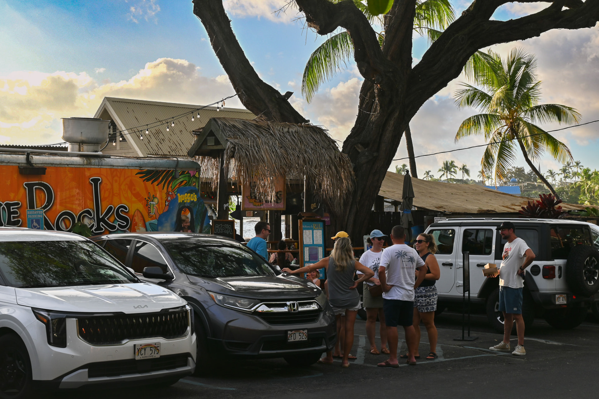 The painted entrance and thatched hale at the arrival lot