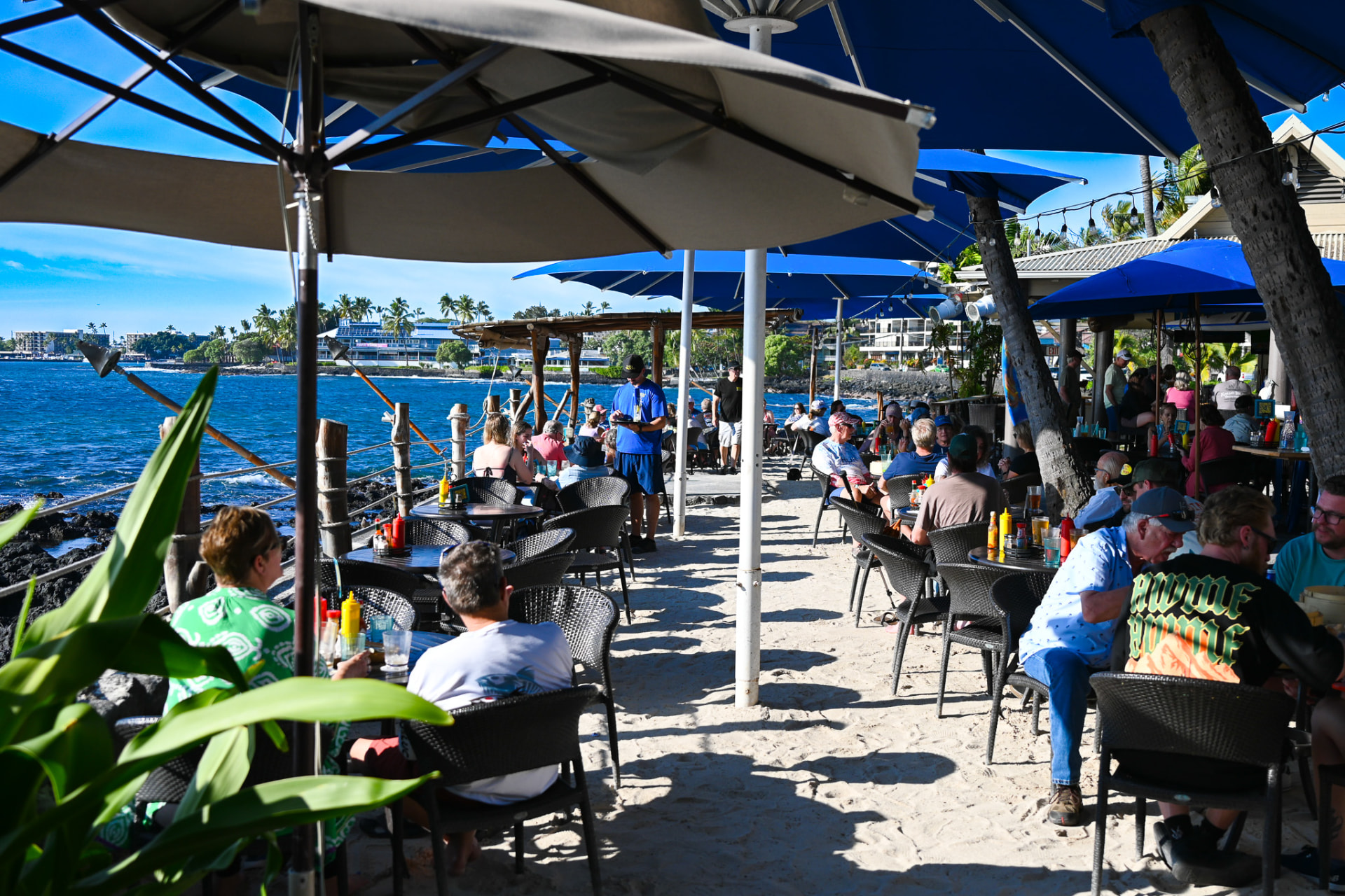 Midday dining on the sand beside the lava rock shoreline